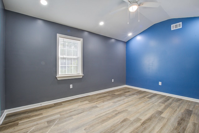 spare room with ceiling fan, light hardwood / wood-style floors, and lofted ceiling