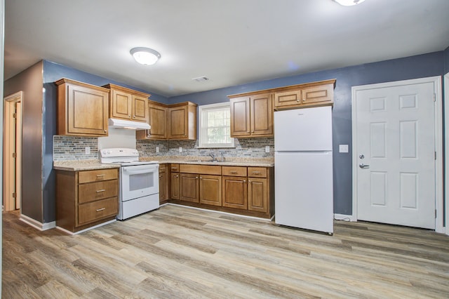 kitchen featuring white appliances, light hardwood / wood-style floors, tasteful backsplash, and sink