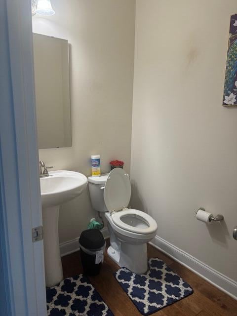 bathroom with hardwood / wood-style floors and toilet