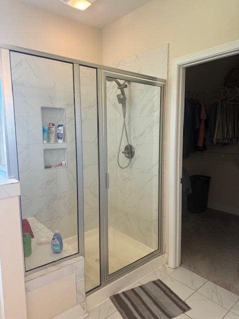 bathroom featuring a shower with door