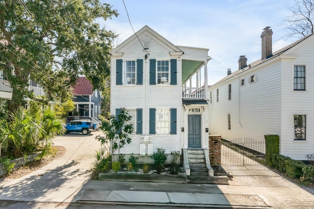 view of front of house featuring a balcony