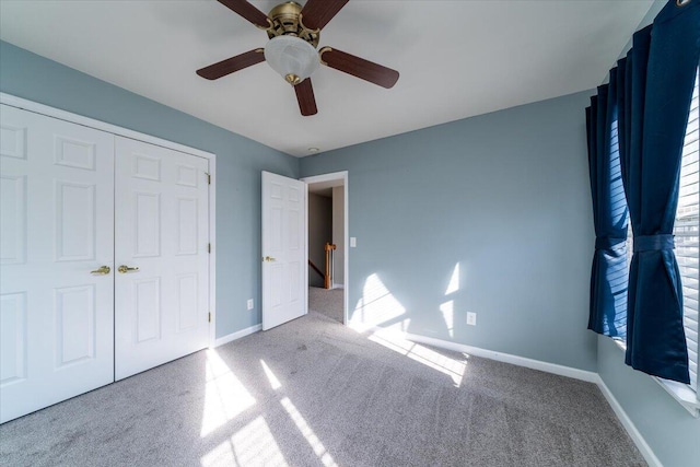 unfurnished bedroom with light carpet, ceiling fan, and a closet