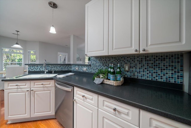 kitchen with white cabinetry, dishwasher, sink, backsplash, and kitchen peninsula