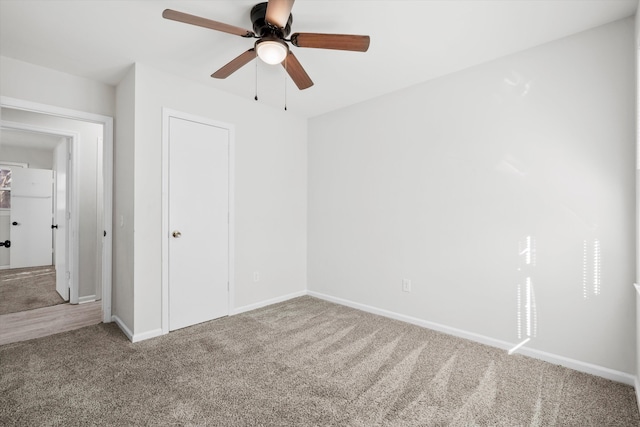 unfurnished bedroom with carpet, baseboards, a closet, and ceiling fan