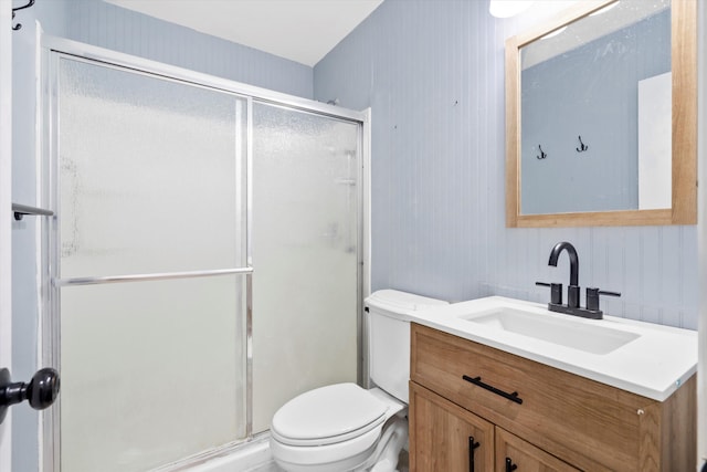 full bathroom with a shower stall, toilet, and vanity