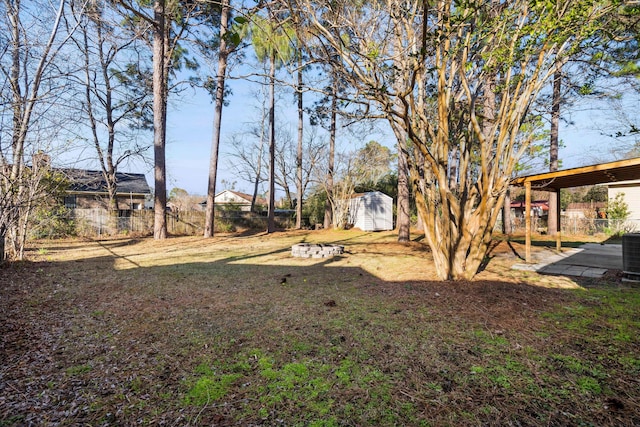 view of yard with a fenced backyard, a shed, a patio area, and an outdoor structure