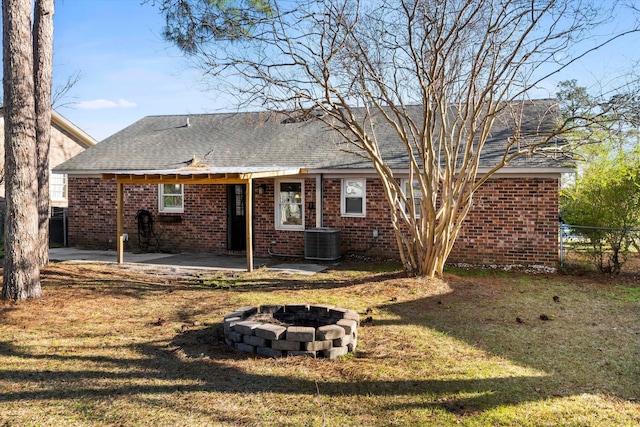 back of house with a yard, fence, brick siding, and a patio area