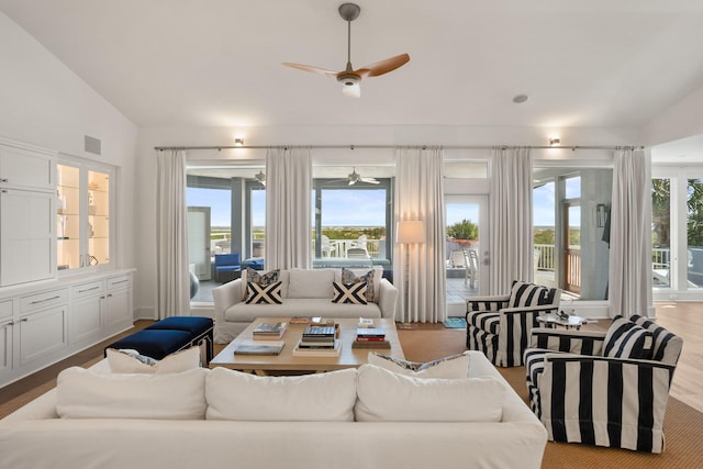 sunroom / solarium with ceiling fan and vaulted ceiling