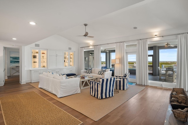 living room featuring ceiling fan, hardwood / wood-style flooring, and vaulted ceiling