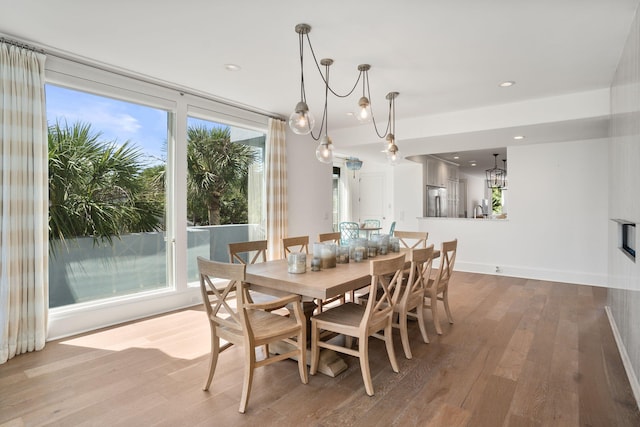 dining area featuring a notable chandelier and light wood-type flooring