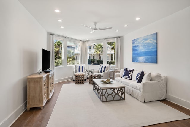 living room with ceiling fan and dark wood-type flooring