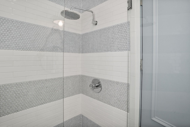 bathroom with a shower with door