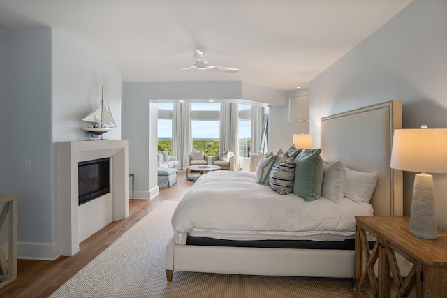 bedroom with ceiling fan and hardwood / wood-style flooring