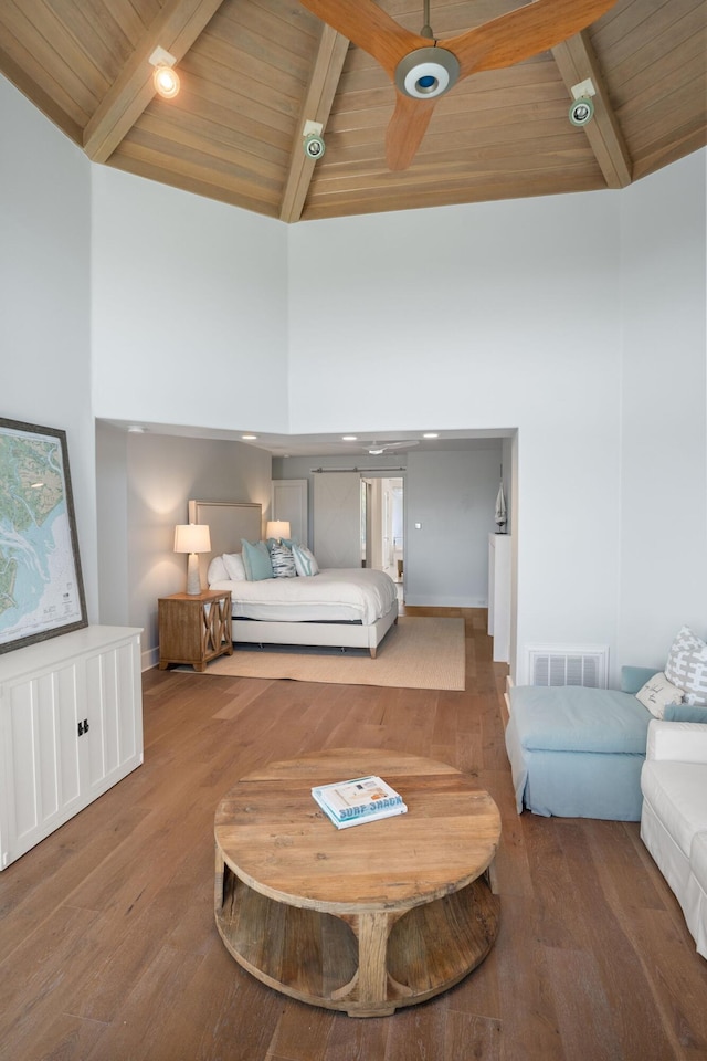 bedroom with wood-type flooring, beamed ceiling, and wood ceiling