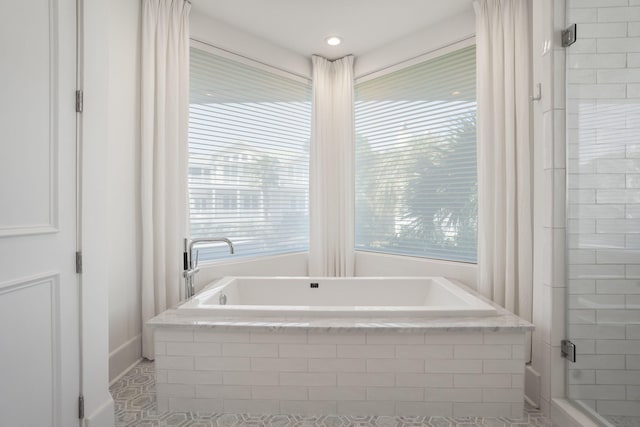 bathroom featuring shower with separate bathtub and tile patterned flooring