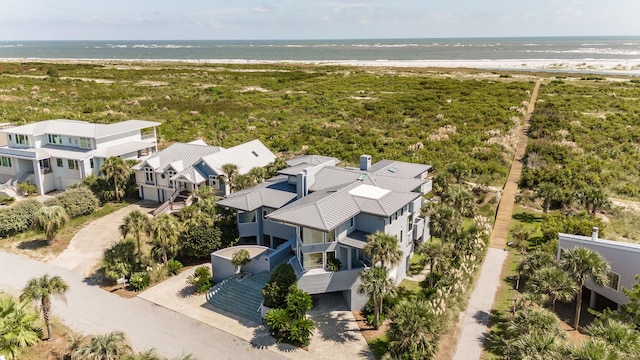 birds eye view of property featuring a water view and a beach view