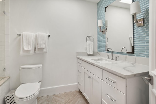 bathroom with vanity, toilet, and tiled shower