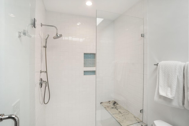 bathroom with toilet and an enclosed shower