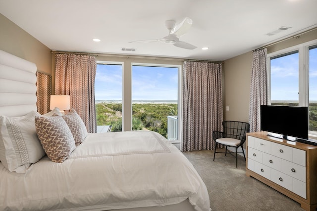 carpeted bedroom featuring ceiling fan and multiple windows