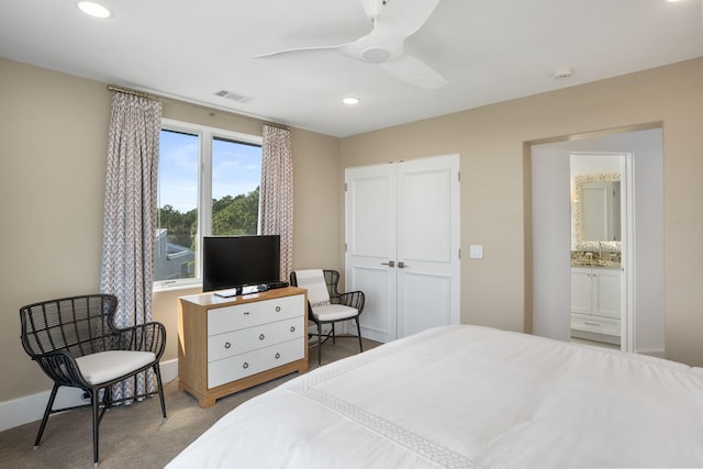 carpeted bedroom featuring sink and ceiling fan