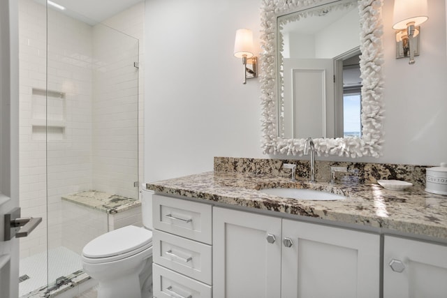 bathroom featuring vanity, toilet, and an enclosed shower