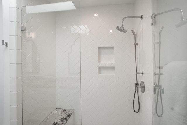 bathroom with tiled shower