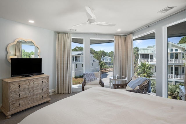 carpeted bedroom with ceiling fan and access to exterior