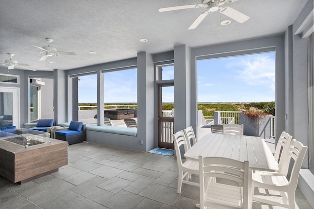 sunroom featuring ceiling fan