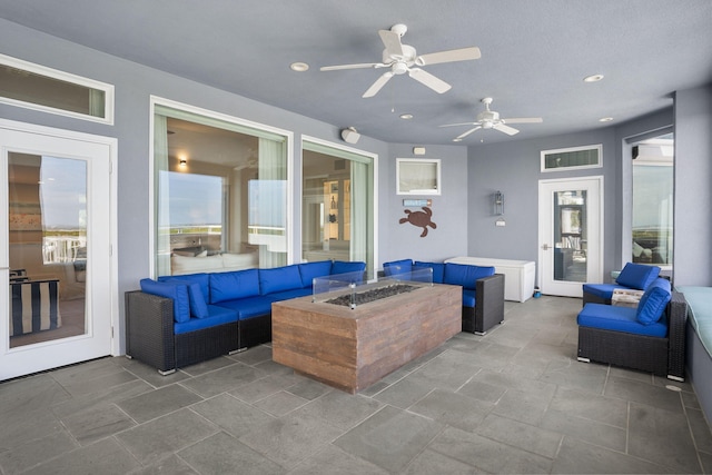 view of patio featuring an outdoor living space with a fire pit and ceiling fan