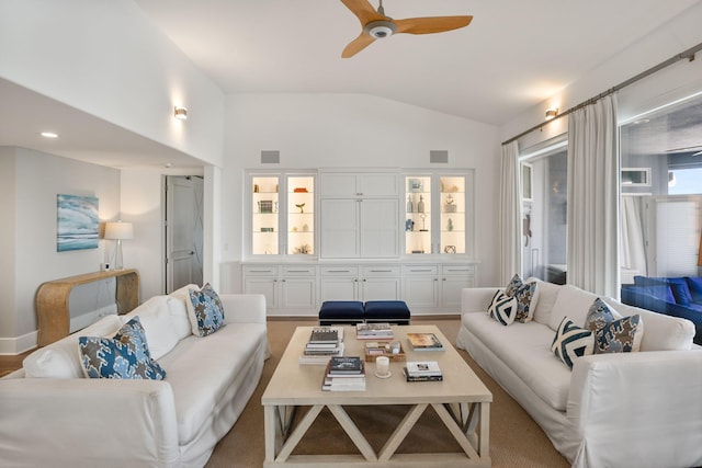 living room with ceiling fan and vaulted ceiling