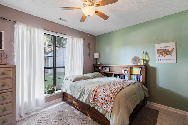 tiled bedroom featuring a textured ceiling and ceiling fan