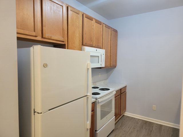 kitchen featuring dark hardwood / wood-style floors and white appliances