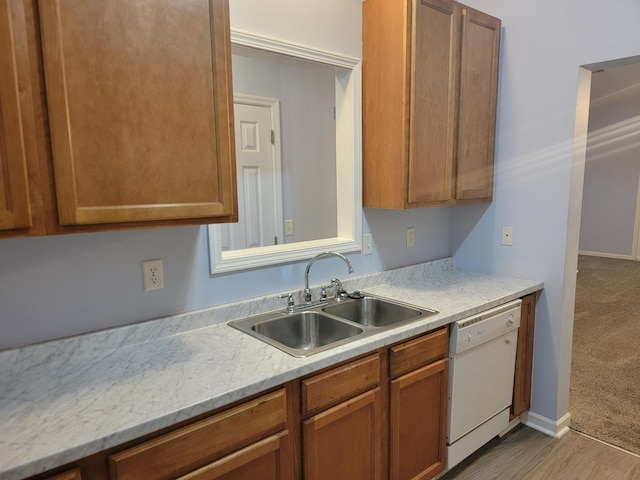 kitchen featuring light stone countertops, sink, white dishwasher, and light hardwood / wood-style flooring