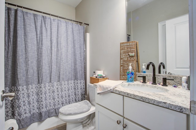 bathroom with vanity, toilet, and curtained shower