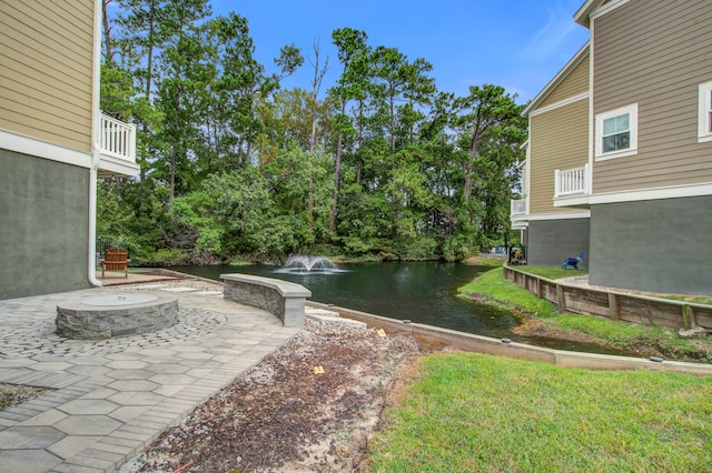 view of yard featuring a water view and a patio area