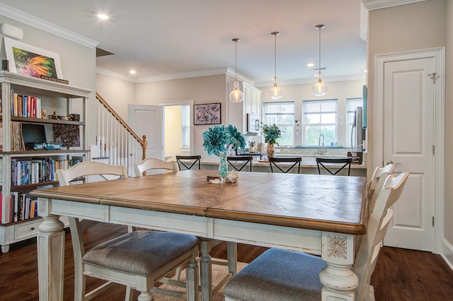 dining space featuring ornamental molding and dark wood-type flooring