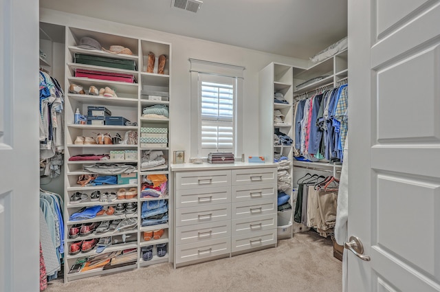 spacious closet featuring visible vents and light carpet