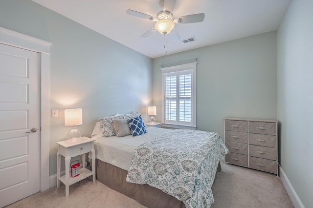 bedroom featuring light colored carpet, visible vents, ceiling fan, and baseboards