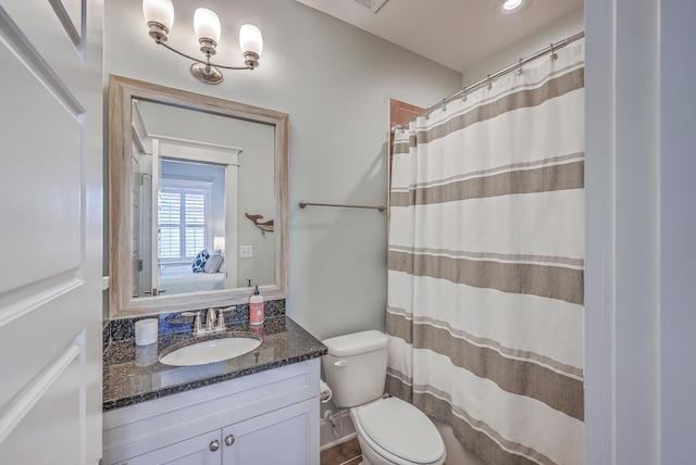 full bathroom featuring curtained shower, vanity, and toilet