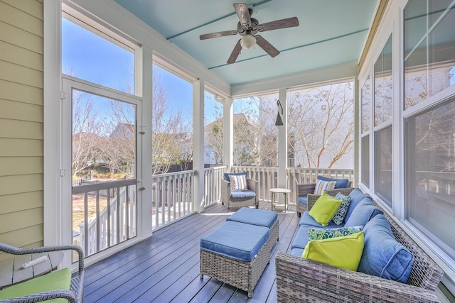 sunroom / solarium featuring a ceiling fan