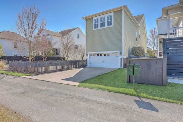 traditional home featuring concrete driveway, a front lawn, an attached garage, and fence