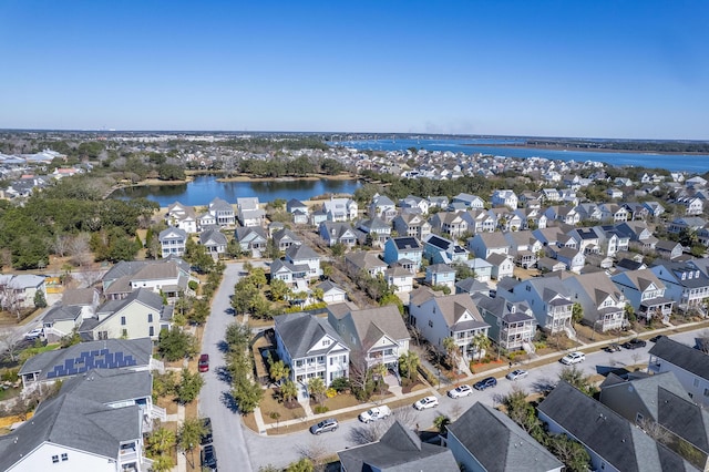 drone / aerial view with a residential view and a water view