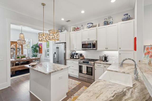 137 Bratton Cir, Mount Pleasant, SC 29464 - kitchen featuring stainless steel appliances, a sink, crown molding, backsplash, and light stone countertops