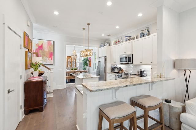137 Bratton Cir, Mount Pleasant, SC 29464 - kitchen with appliances with stainless steel finishes, a peninsula, ornamental molding, decorative backsplash, and a center island