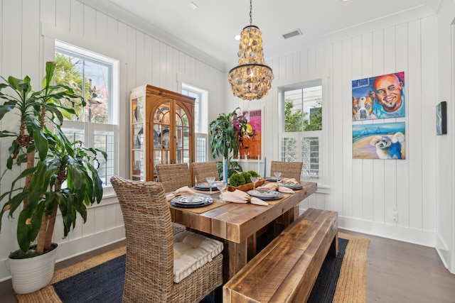 137 Bratton Cir, Mount Pleasant, SC 29464 - dining space featuring a chandelier, dark wood-type flooring, ornamental molding, baseboards, and wood walls