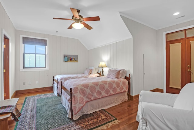 bedroom with ceiling fan, wood finished floors, baseboards, vaulted ceiling, and ornamental molding