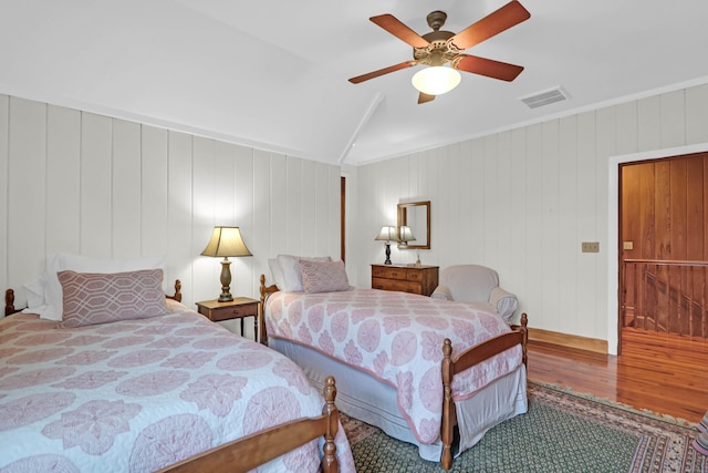 bedroom with lofted ceiling, wood finished floors, visible vents, and a ceiling fan