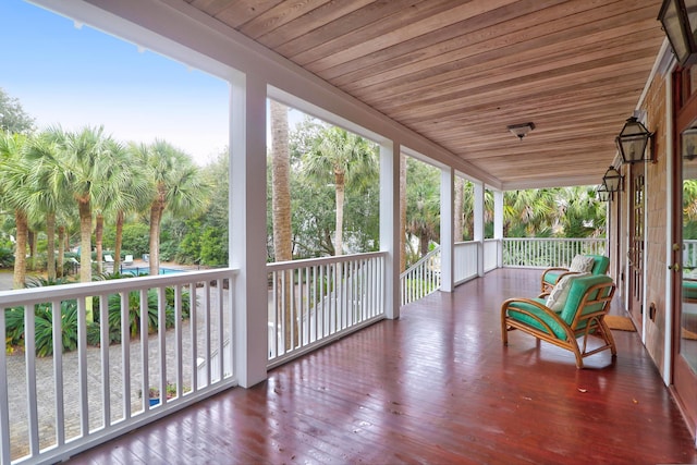 sunroom featuring wooden ceiling