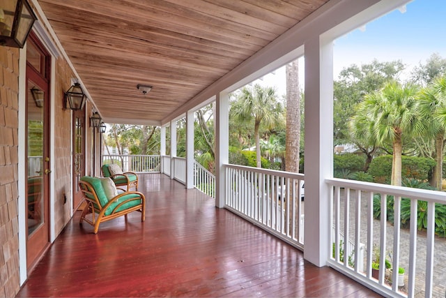 unfurnished sunroom with wood ceiling