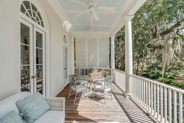 sunroom featuring decorative columns, ceiling fan, and french doors